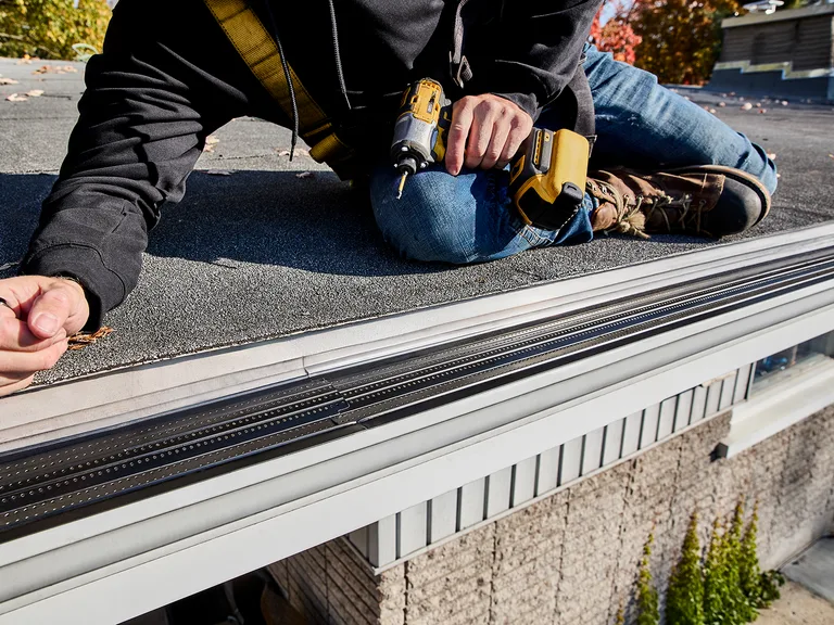 Installer fitting an Alu-Rex gutter guard