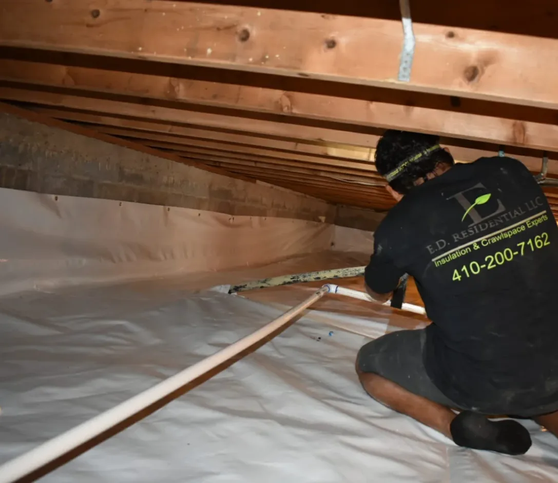 Ed Residential LLC crew member at work in a crawlspace